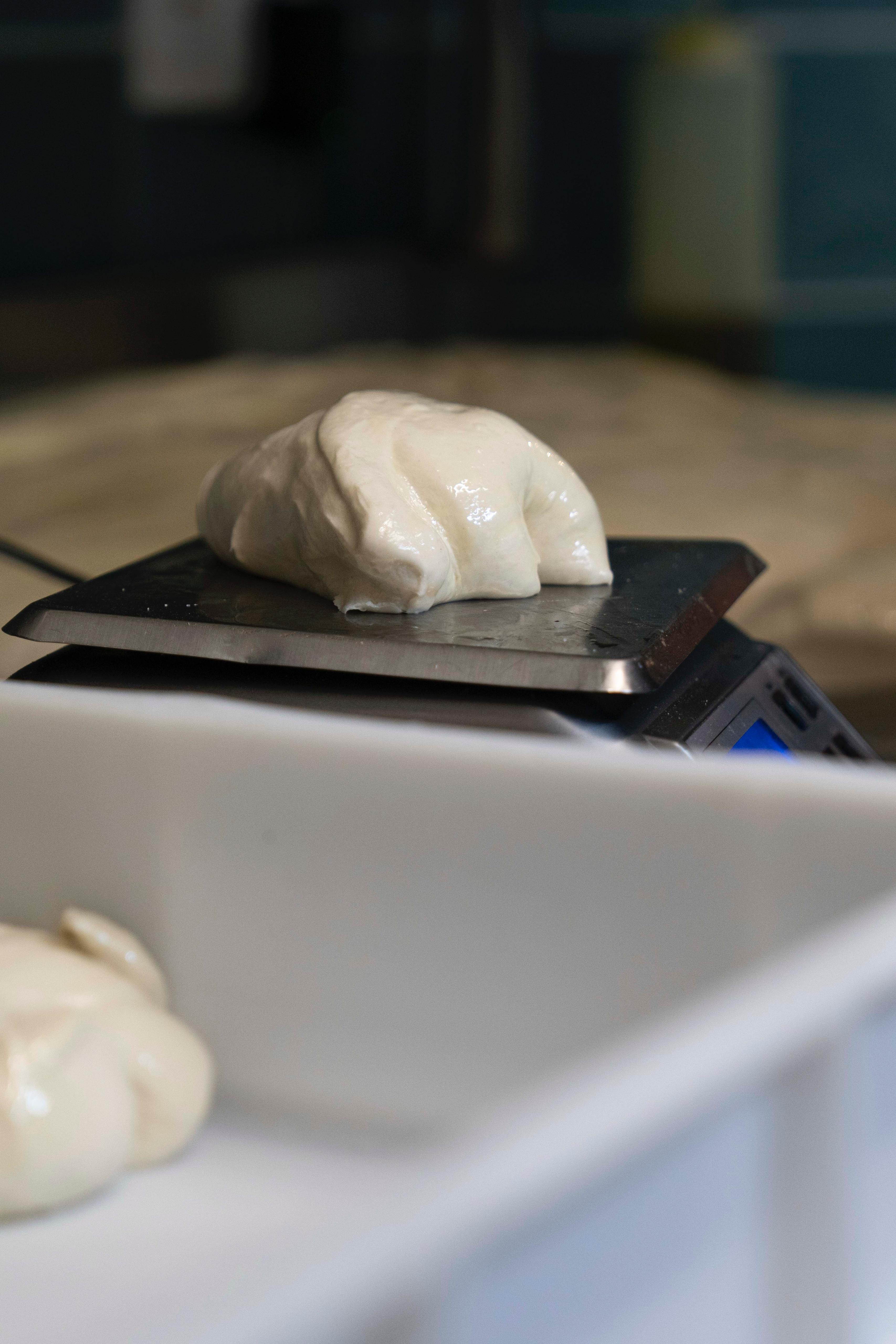 Weighing dough on scale at Kalura, Antwerp
