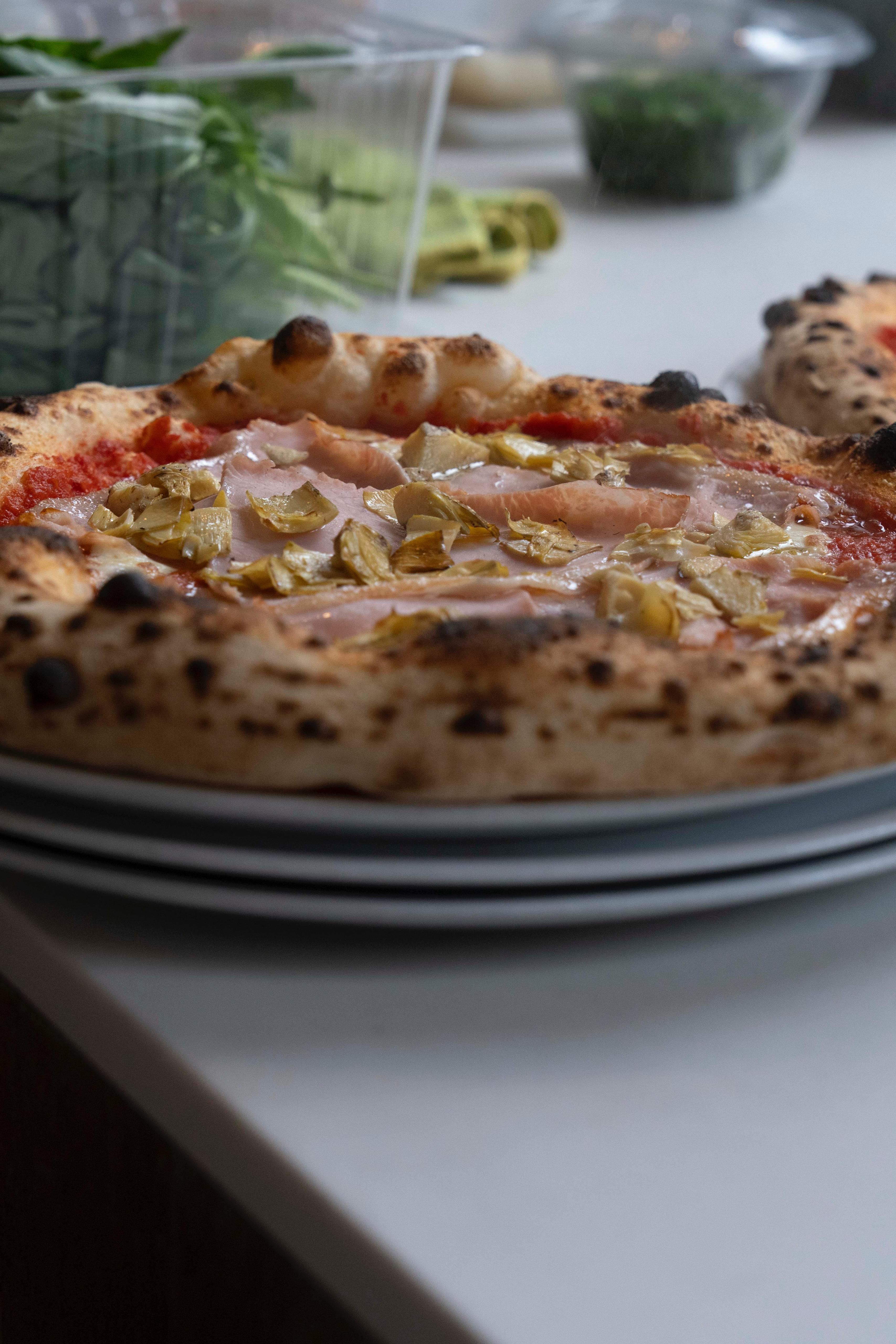 Pizza with ham and artichokes close-up at Kalura, Antwerp